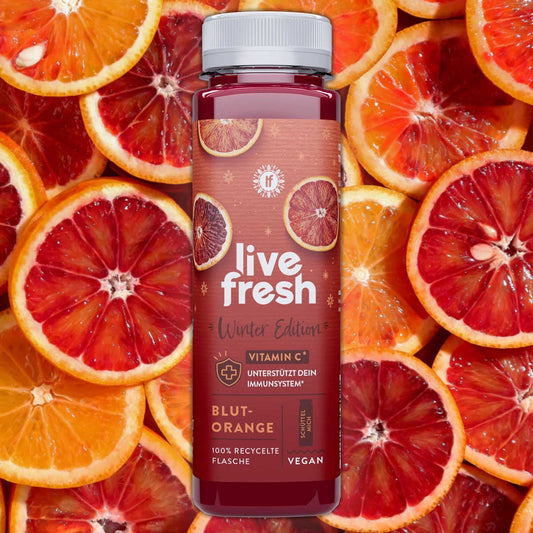 Blutorangensaft von LIveFresh in der Winter Edition mit Blutorangen im Hintergrund